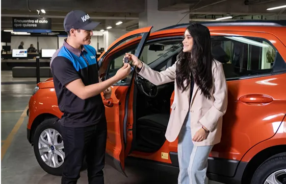 A man and a woman standing next to a car.